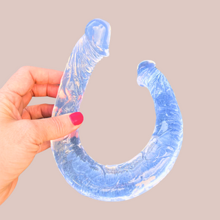 Another view of the transparent double ended dildo, you can that the colour runs right through it and the hand gives an idea of size.