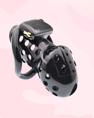 The Air One chastity cage in black is shown fully assembled with it's brass padlock fixed in place.