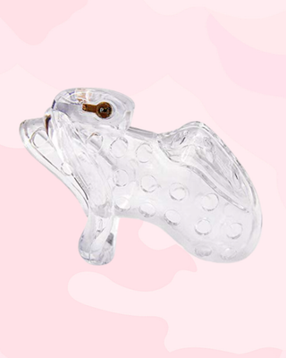 A side view of the Air One chastity cage in transparent, it is shown in front of a pink background.