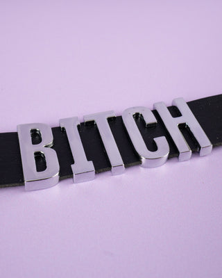 Black bitch collar layed out flat.