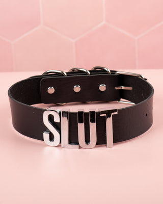 A picture of the slut collar in black showing the spell out.