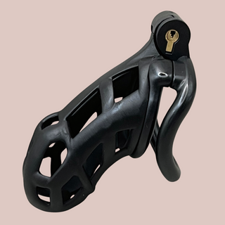 A side view of the Cobra Curved Cuff in Small size, you can see the standard length chastity device, it is shown with it's integral lock fitted and curved base ring.