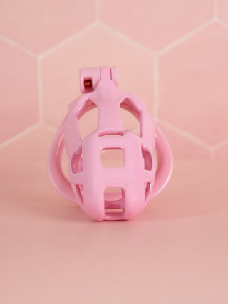 A front on view of the Cobra Double Cuff chastity cage, this small cage has a cutout design for air flow, urination and cleaning.