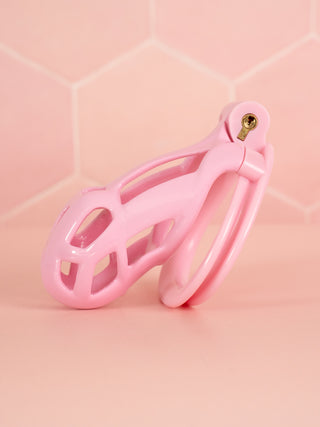 A side view of the Cobra Double Cuff, the small chastity cage is shown with the base ring and integral lock fitted to the cage.