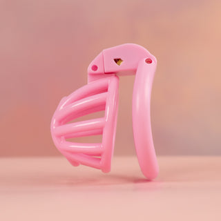 A side view of the pink Cobra Nub chastity cage, you can see the angled base ring.
