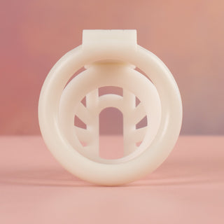 A rear view of the white Cobra Nub chastity cage, the view looks through the base ring and into the cage.