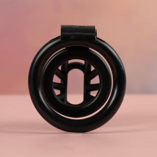 A rear view of the black Cobra Nub Chastity Device, the view is looking through the base ring and into the cage.