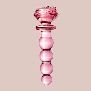 A full length view of the rose pink glass beaded dildo, you can see the smooth beads that make up the body.