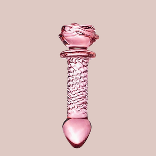 A full view of the rose pink glass dildo, this angle shows the smooth head and textured body.