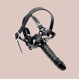 An angled view of the double ended harness with penis gag. You can see how the head harness will fit over the head and the two ends of the gag.