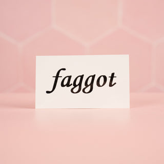 A close up of the single Faggot Tattoo, the black lettering is all that will transfer to the body.