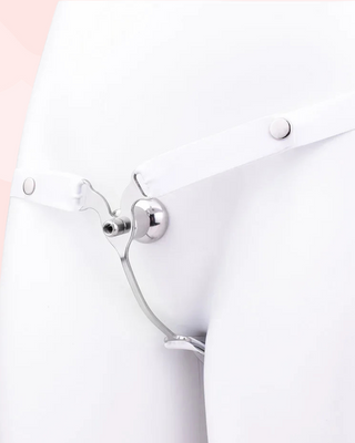 A front view of the Femme Fantasy Chastity Cage with white belt fitted, it is shown on a model.