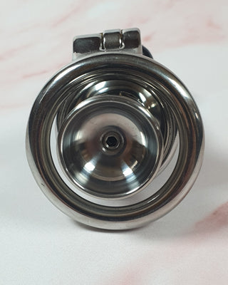 A rear view of the Flat Gatling Thruster chastity cage with the urethral cup in view
