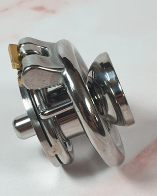 The Flat Gatling Thruster chastity cage shown with the urethral cup attached.