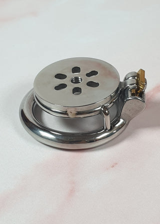The Flat Gatling Thruster F Chastity Cage is shown with the dildo and urethral cup removed. The flat chastity cage and flat base ring are fixed in place with the integral lock.
