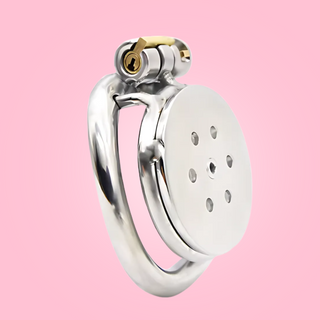 An angled view of the Flat Gatling Chastity Cage, you can see the flat micro style cage, curved base ring and integral lock fixed in place.