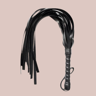 The whip shown on its own, you can see the handle and tassels.