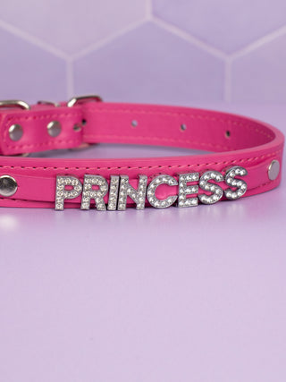 A close up of the Rhinestone lettering spelling out Princess, it is on a plain strap with stud attachments.
