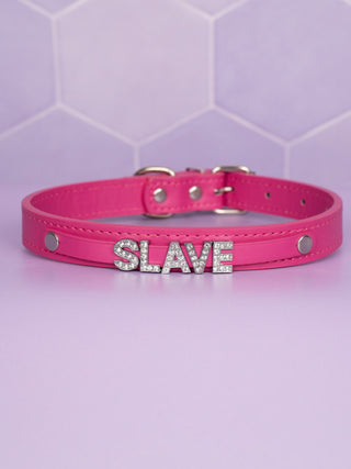 The hot pink collar has SLAVE rhinestone lettering on a separate strap which creates a raised look.