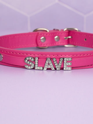 A close up of the SLAVE rhinestone lettering.