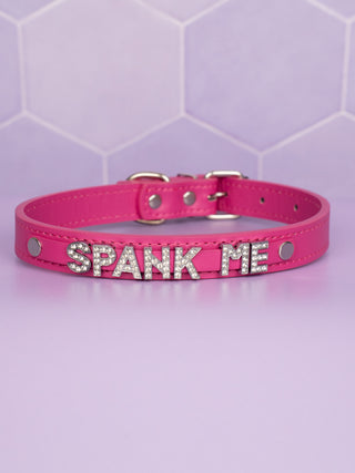 A full view of the hot pink collar, the diamante Spank Me is clear to see, it sits on a matching hot pink studded proud of the bases collar.