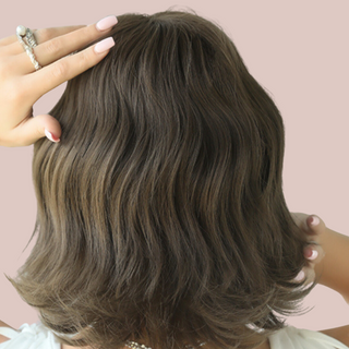 Here is the stunning ash-brown chin-length wig from House of Chastity. It has been styled with a soft wave running through it. It comes with a straight fringe. View is of the back of the wig