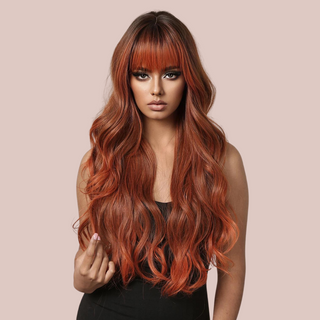 HOC373-1 Long Length Soft Styled Wig modelled for House of Chastity. A beautiful soft red wig with blonde highlights running through it. that is shown styled in a long flowing look with a fringe.