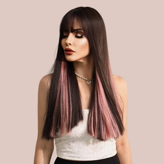 An on trend long length straight haired wig with pink highlights running through