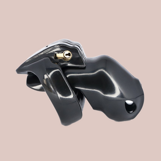 Shown is the black nano cock cage that we offer in our version of the Holy Trainer range. It is shown from the side angle so that you have a full view of the assembled chastity cage, the cock cage is shown attached to a base ring and the integral lock is in place, showing how it fits to the body. This product is the black version, these cages also come in pink and clear.