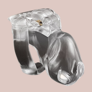 Shown is the clear nano cock cage that we offer in our version of the Holy Trainer range. It is shown from the side angle so that you have a full view of the assembled chastity cage, the cock cage is shown attached to a base ring and the integral lock is in place, showing how it fits to the body. This product is the clear version, these cages also come in pink and black