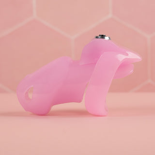 A side view of the HT V5 Standard chastity cage in pink, you can see the shaped base ring.