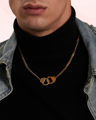 The Gold Handcuff Necklace shown being modelled by a man, this is the 18 inch length design