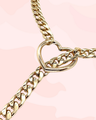 A close up view of the heart pendant which the choker chain slides through.