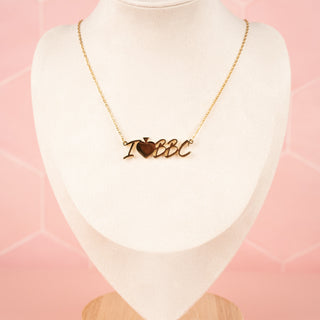 I heart BBC necklace in gold displayed on mannequin to show how it would sit on neckline.