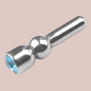 An alternate angle of The Blue Jewelled Urethral Dilator from House Of Chastity. A close up of the small dilator so that you can see the jewelled end.
