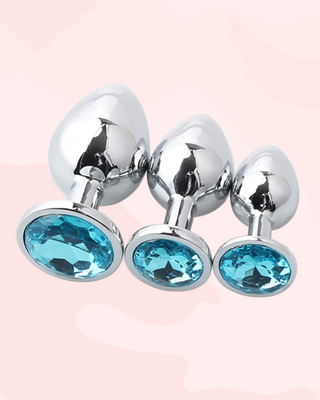 Three metallic anal plugs in small, medium and large, with blue gemstones