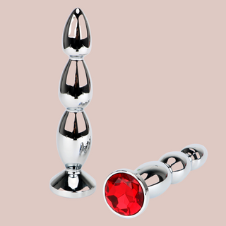 The red long length anal plug shown from two different angles.