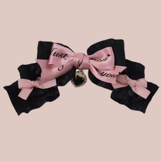 A close up of the Just You bow hair clip, you can see the  black and pink contrasting.