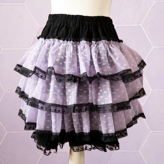 The rear view of the purple and black Kawaii Cake Skirt