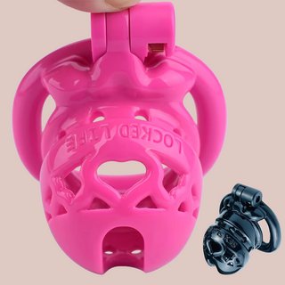 The Locked Life Chastity Cages from House Of Chastity, they are shown here in pink and black, with the words LOCKED LIFE and SEX SLAVE imprinted on the top.