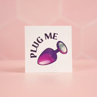 The Plug Me temporary tattoo shows the image of a butt plug with a diamante end, and the words Plug Me above it.