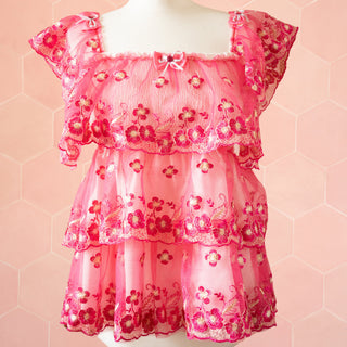 A front view of the ruffled dress, you can see the sheer embroidered fabric, layer effect and detailed embroidery.