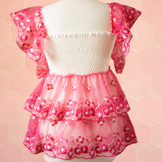 The rear view of the dress, you can see the stretch style bodice, the sheer fabric with under petticoat which continues around the skirt and the draped sleeves.