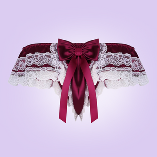 The rear view of the satin and lace tanga panties. You can see the large bow at the rear and the decorative lace edging.