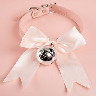 The pink soft ribbon collar bow from House Of Chastity, shown is the pink collar, matching soft satin ribbon and silver bell perfect attire for any sissy.