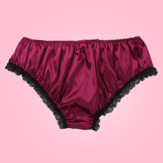 Back view, Adult knickers for men, sissy, lgbt, unisex. Made in red wine satin with black lace detailing to the legs and panels on each side. There are also matching red wine satin bows prettily applied.