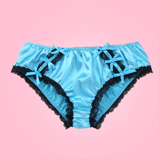 Shown unworn, Adult knickers for men, sissy, lgbt, unisex. Made in blue satin with black lace detailing to the legs and panels on each side. There are also matching blue satin bows prettily applied.