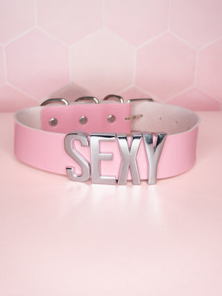 The pale pink collar with silver SEXY lettering