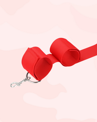 A close up of the red wrist cuffs and trigger for adding extra toys.