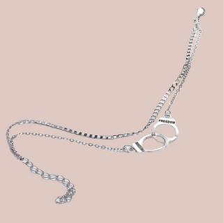 The silver handcuff ankle chain show laid out.